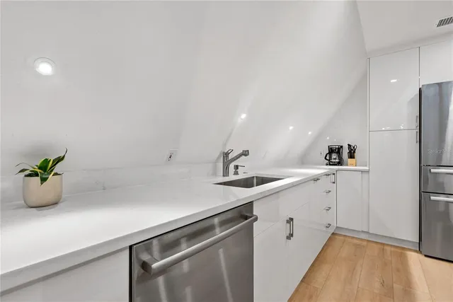a kitchen with a sink and white cabinets