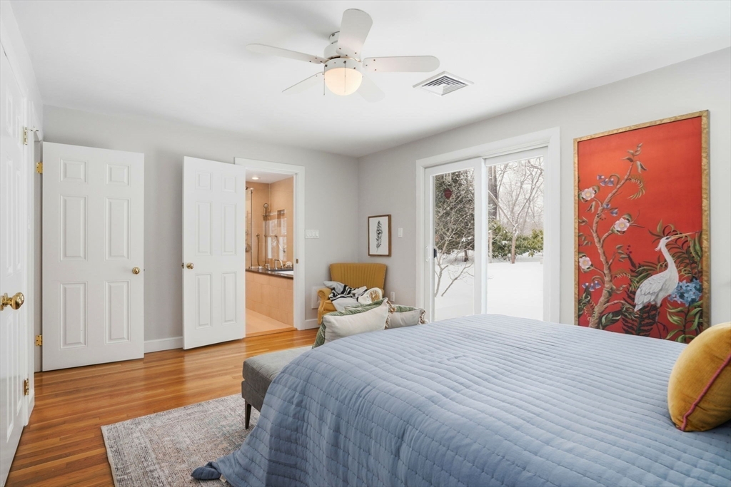 7 Baskin Road Lexington, MA 02421 - Photo 13 of 23 a bedroom with a bed and wooden floor