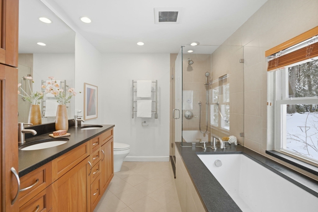 7 Baskin Road Lexington, MA 02421 - Photo 14 of 23 a large bathroom with a tub sink shower and mirror