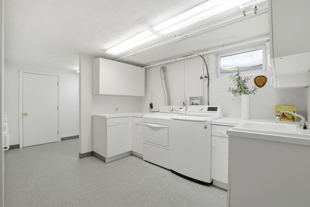 7 Baskin Road Lexington, MA 02421 - Photo 20 of 23 a view of a sink and dishwasher with white cabinets