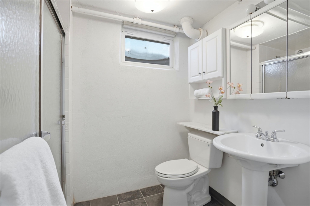 7 Baskin Road Lexington, MA 02421 - Photo 21 of 23 a bathroom with a sink and mirror with toilet