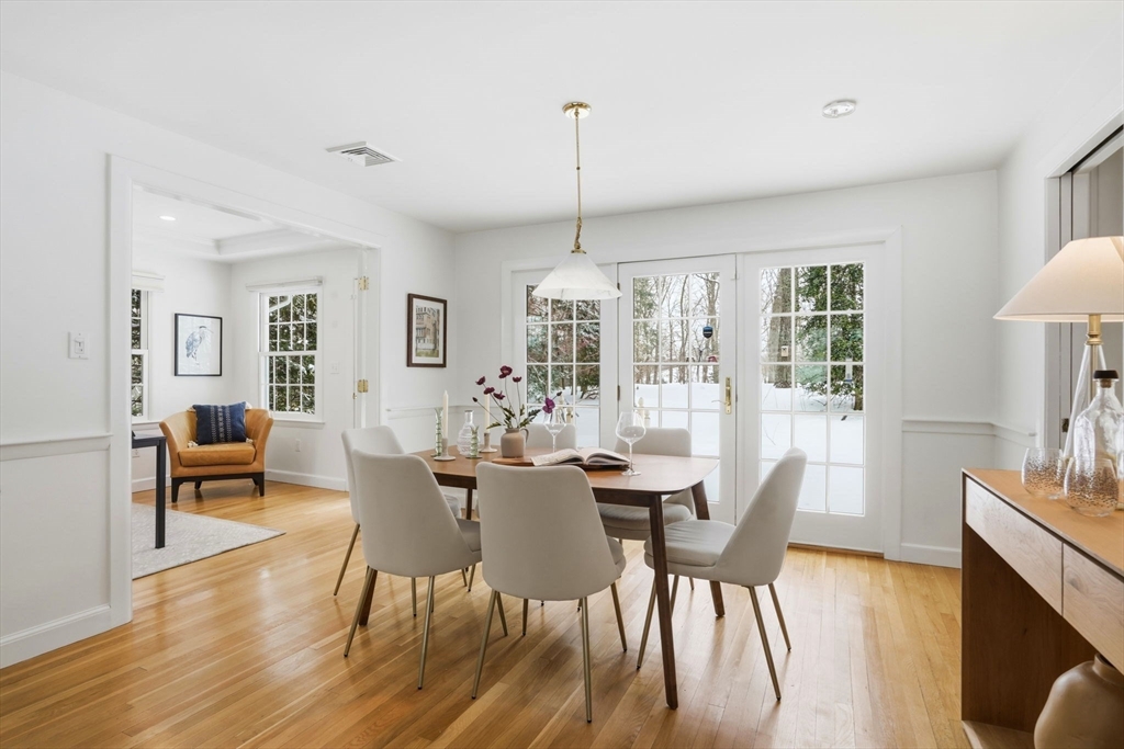 7 Baskin Road Lexington, MA 02421 - Photo 6 of 23 a dining room with furniture a chandelier and wooden floor