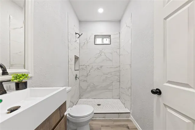 a bathroom with a sink toilet and shower
