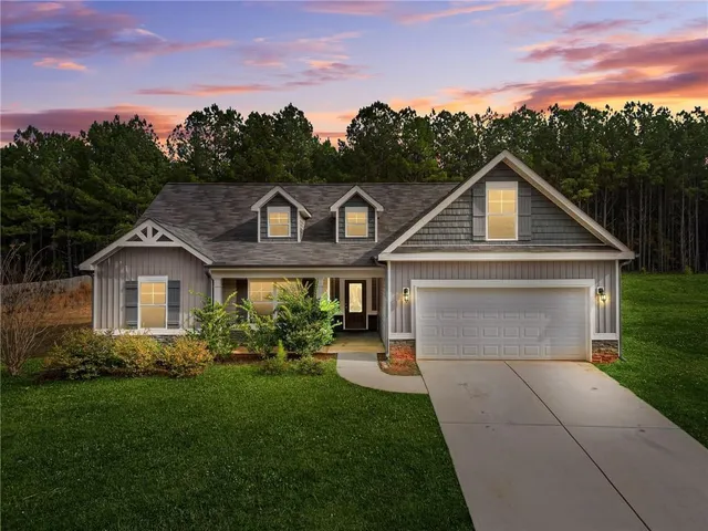 a front view of a house with a garden