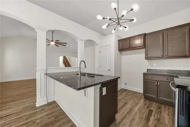 a kitchen with sink cabinets and chandelier