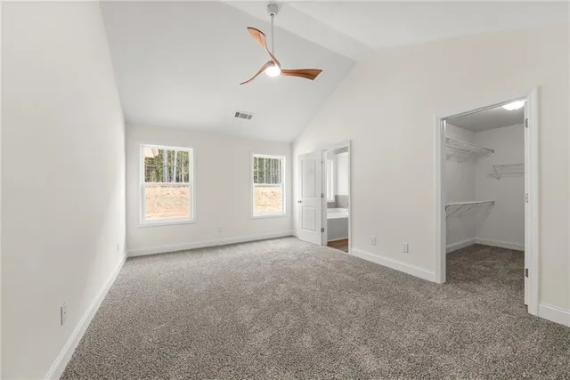 an empty room with windows and closet