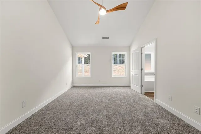 an empty room with windows and closet