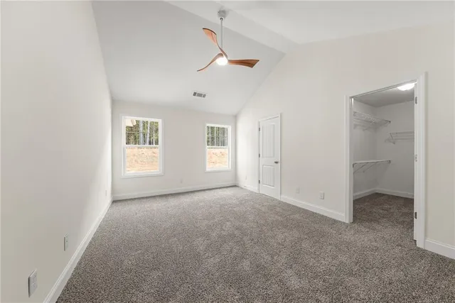 an empty room with windows and closet