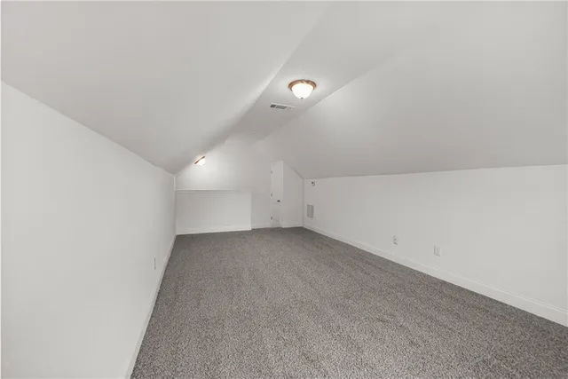 an empty room with a empty space and windows