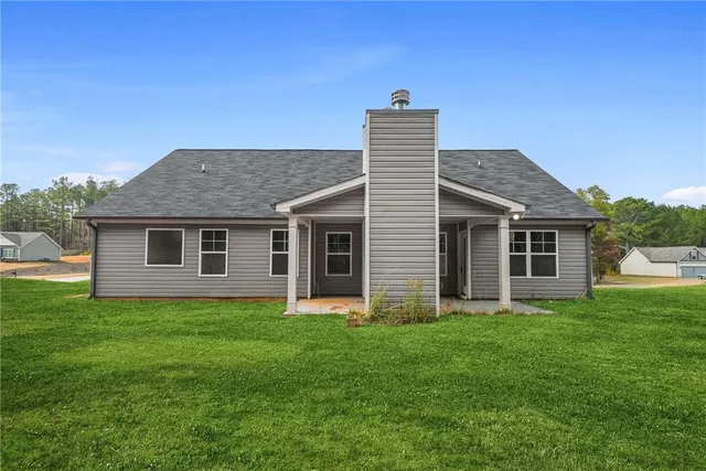 a front view of house with a garden