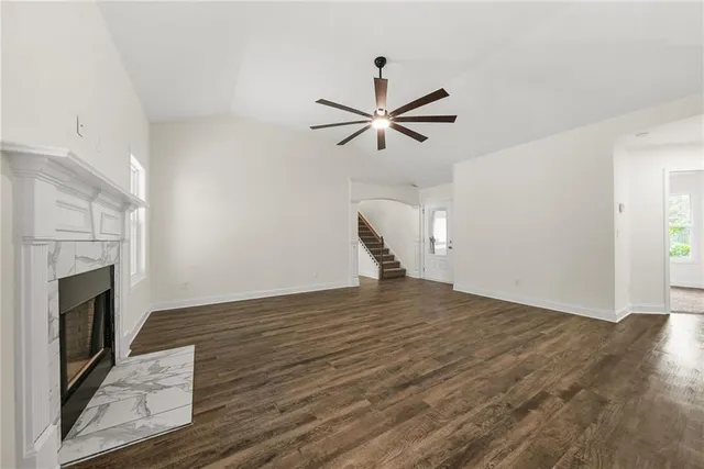 a view of empty room with wooden floor and fireplace