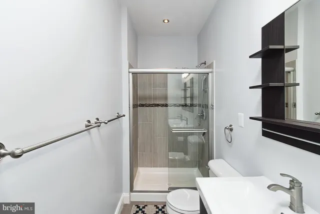 a bathroom with a shower and a toilet