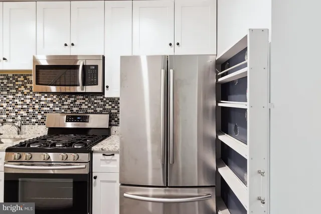 a kitchen with stainless steel appliances a stove and a refrigerator