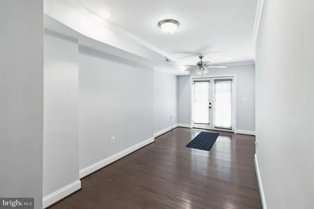 a view of an empty room with wooden floor
