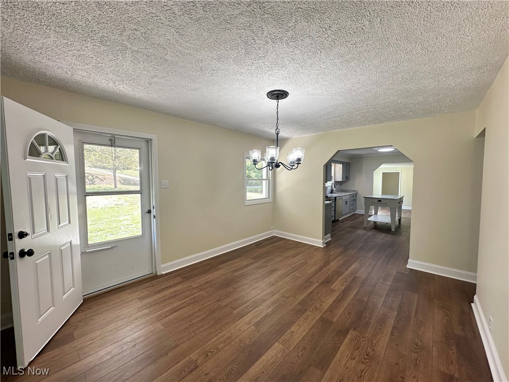 2372 Oak Grv Ext Road St. Marys, WV 26170 - Photo 7 of 23 Dining Roomfeaturing dark wood-type flooring, an inviting chandelier, and a textured ceiling