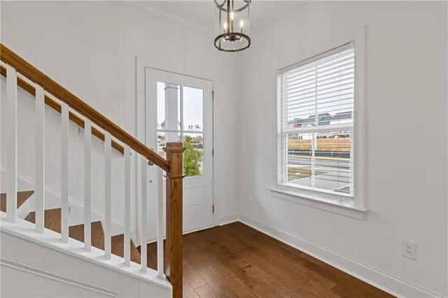 a view of an entryway with wooden floor