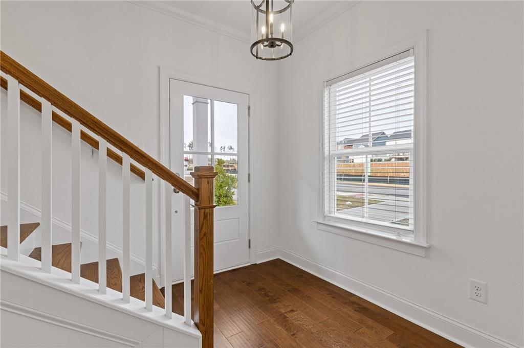 a view of an entryway with wooden floor