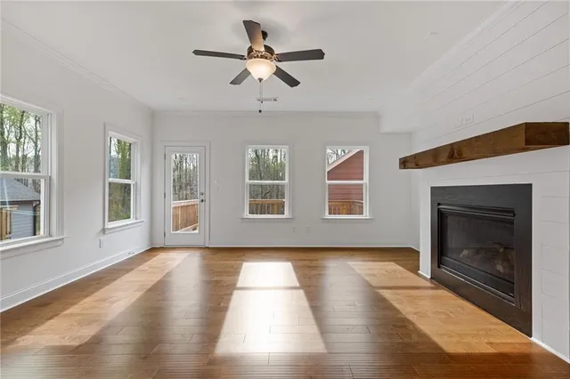 a view of an empty room with exposed radiator and fireplace