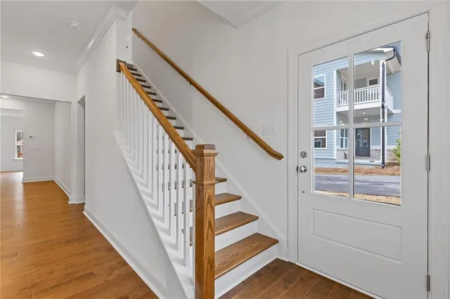 a view of entryway and hall with wooden floor