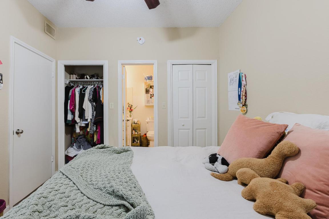 1910 Robbins Place, Unit 207 Austin, TX 78705 - Photo 15 of 28 a bedroom with a bed and a closet