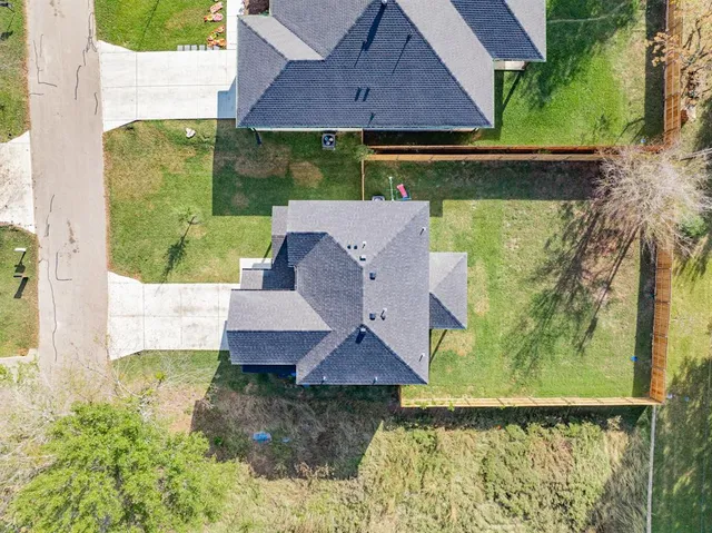 an aerial view of a house with a yard