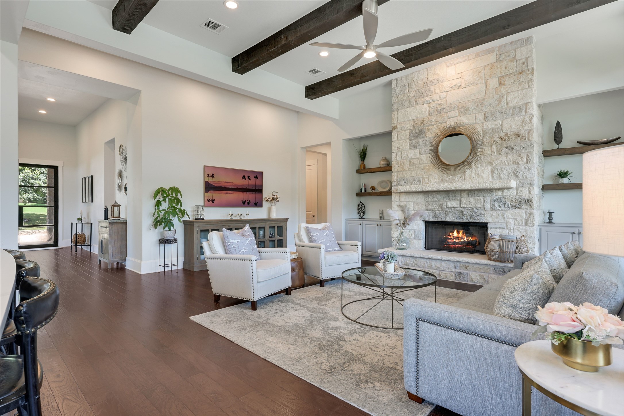 Living room with stone fireplace at 802 Crestone Stream Drive