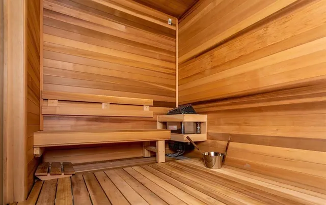 a room with gym equipment and large windows