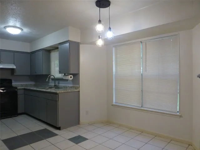 a kitchen with stainless steel appliances granite countertop a sink and cabinets