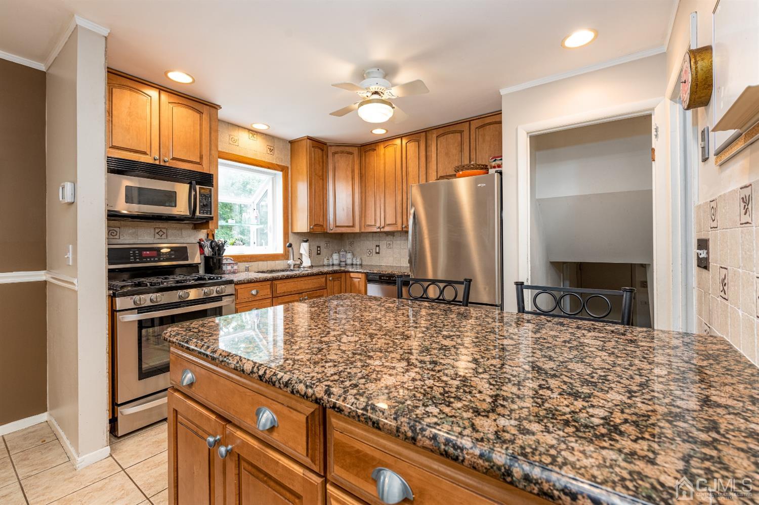 35 Larchmont Road Edison, NJ 08837 - Photo 11 of 23 a kitchen with stainless steel appliances granite countertop a stove a sink and a refrigerator