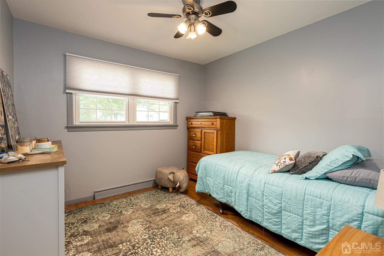 35 Larchmont Road Edison, NJ 08837 - Photo 14 of 23 a bedroom with a bed and wooden floor