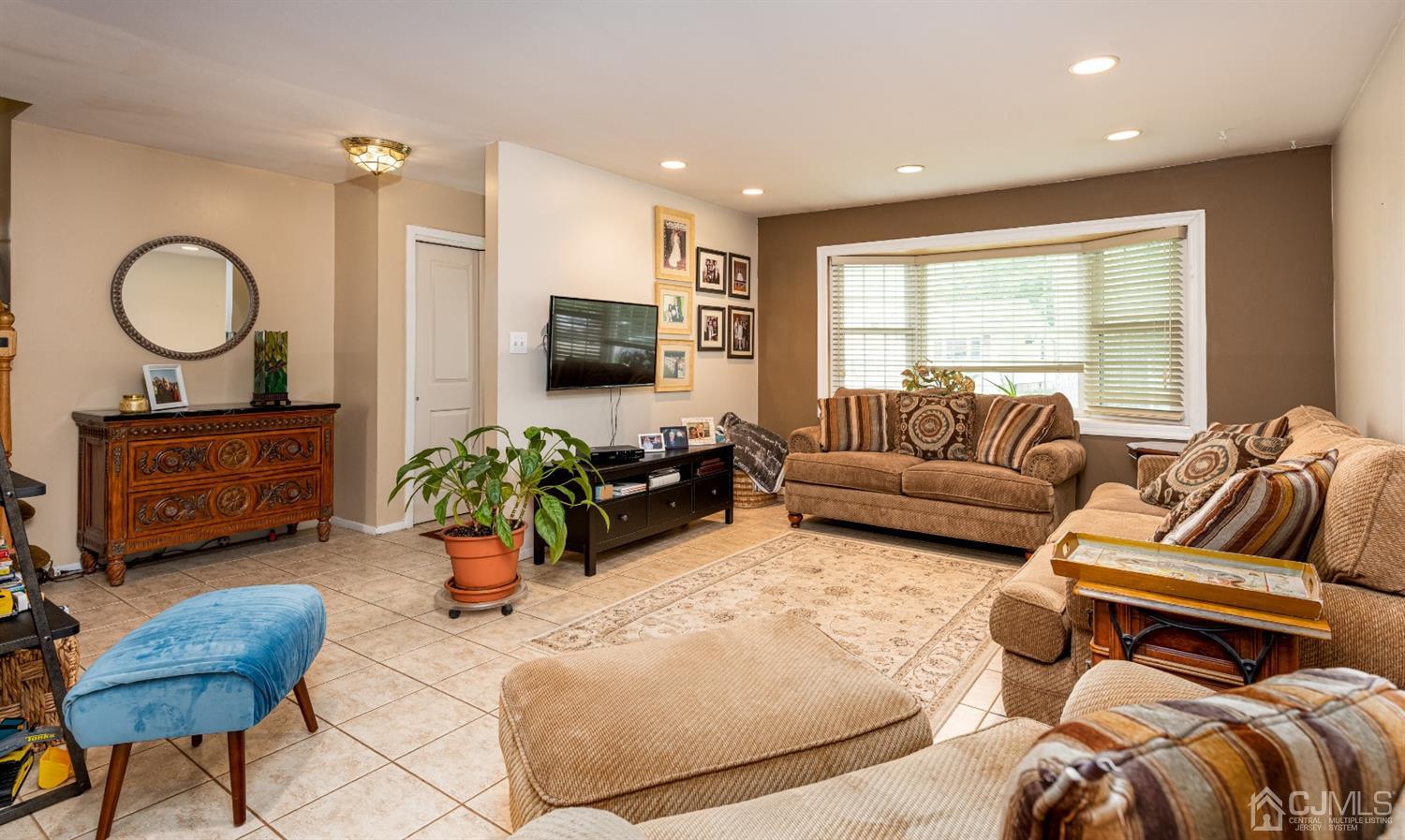 35 Larchmont Road Edison, NJ 08837 - Photo 4 of 23 a living room with furniture a ceiling fan and a window