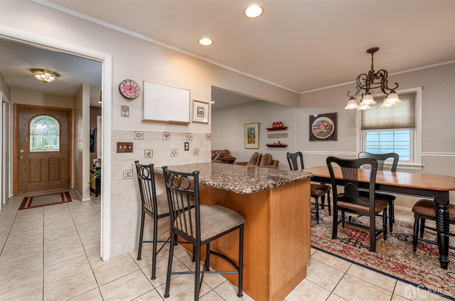 35 Larchmont Road Edison, NJ 08837 - Photo 10 of 23 a kitchen with stainless steel appliances granite countertop table chairs and a refrigerator