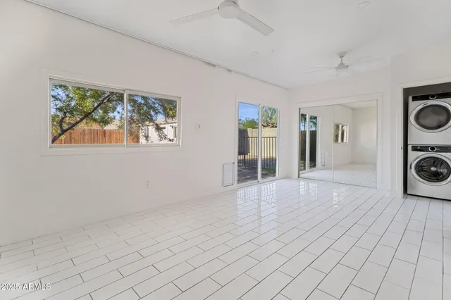 a view of a livingroom with wooden floor and a large window