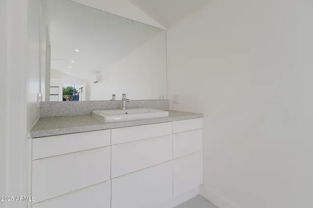a bathroom with a sink and mirror