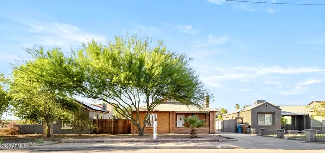 a front view of a building with tree s