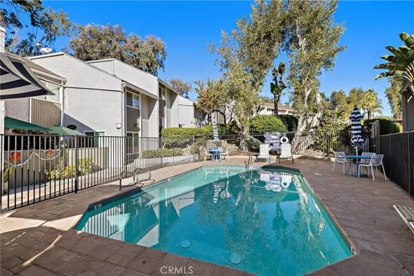 a swimming pool with outdoor seating and yard
