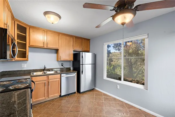 a kitchen with stainless steel appliances granite countertop a stove sink and refrigerator