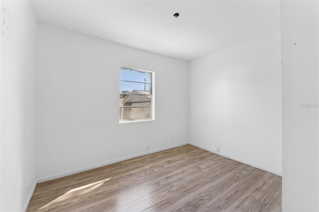 3102 West Leroy Street, Unit A Tampa, FL 33607 - Photo 13 of 21 a view of empty room with wooden floor