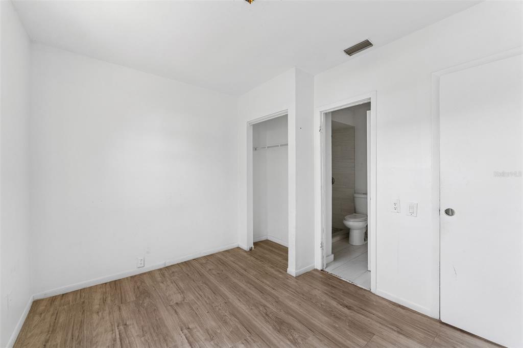3102 West Leroy Street, Unit A Tampa, FL 33607 - Photo 14 of 21 a view of an empty room with wooden floor and closet