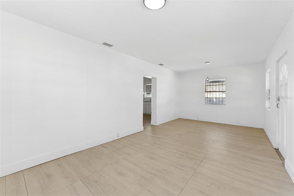 3102 West Leroy Street, Unit A Tampa, FL 33607 - Photo 9 of 21 an empty room with windows and white walls