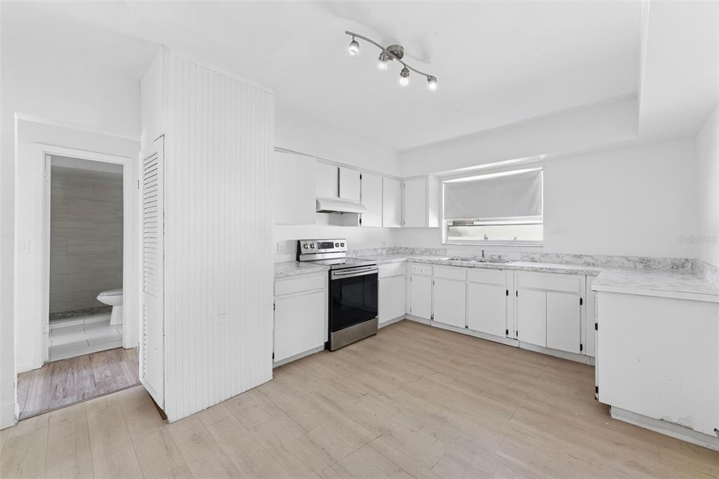 3102 West Leroy Street, Unit A Tampa, FL 33607 - Photo 10 of 21 a kitchen with granite countertop white cabinets and white appliances