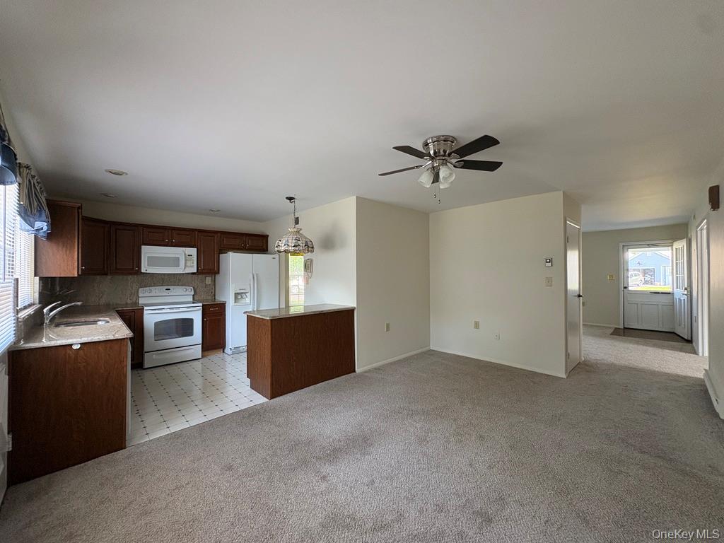 491 Stratford Lane Ridge, NY 11961 - Photo 13 of 24 a view of a livingroom with furniture and a ceiling fan