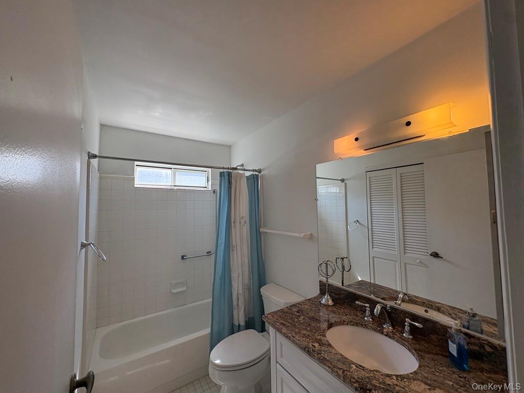 491 Stratford Lane Ridge, NY 11961 - Photo 16 of 24 a bathroom with a granite countertop sink toilet a mirror and shower