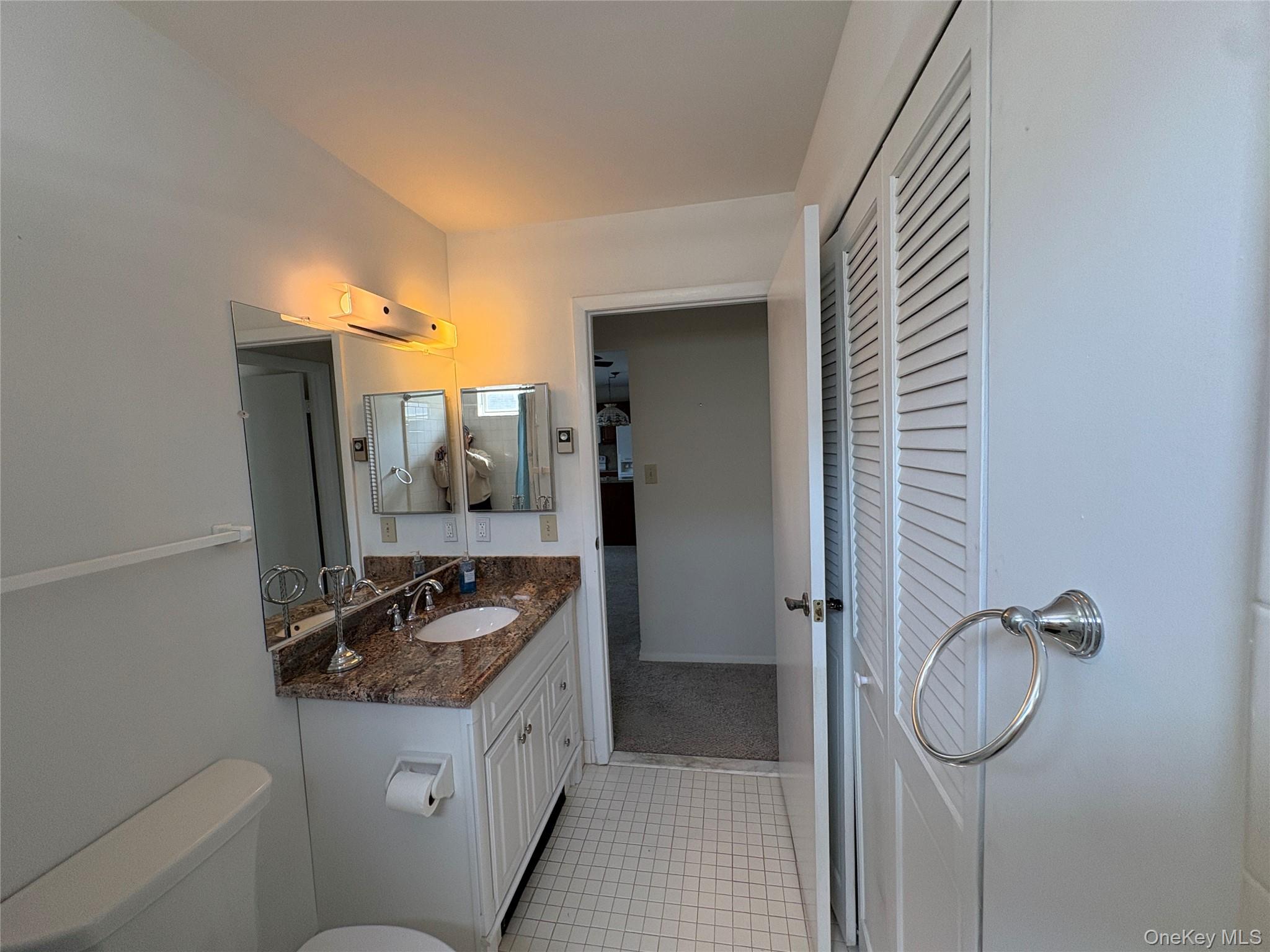 491 Stratford Lane Ridge, NY 11961 - Photo 17 of 24 a bathroom with a sink and mirror