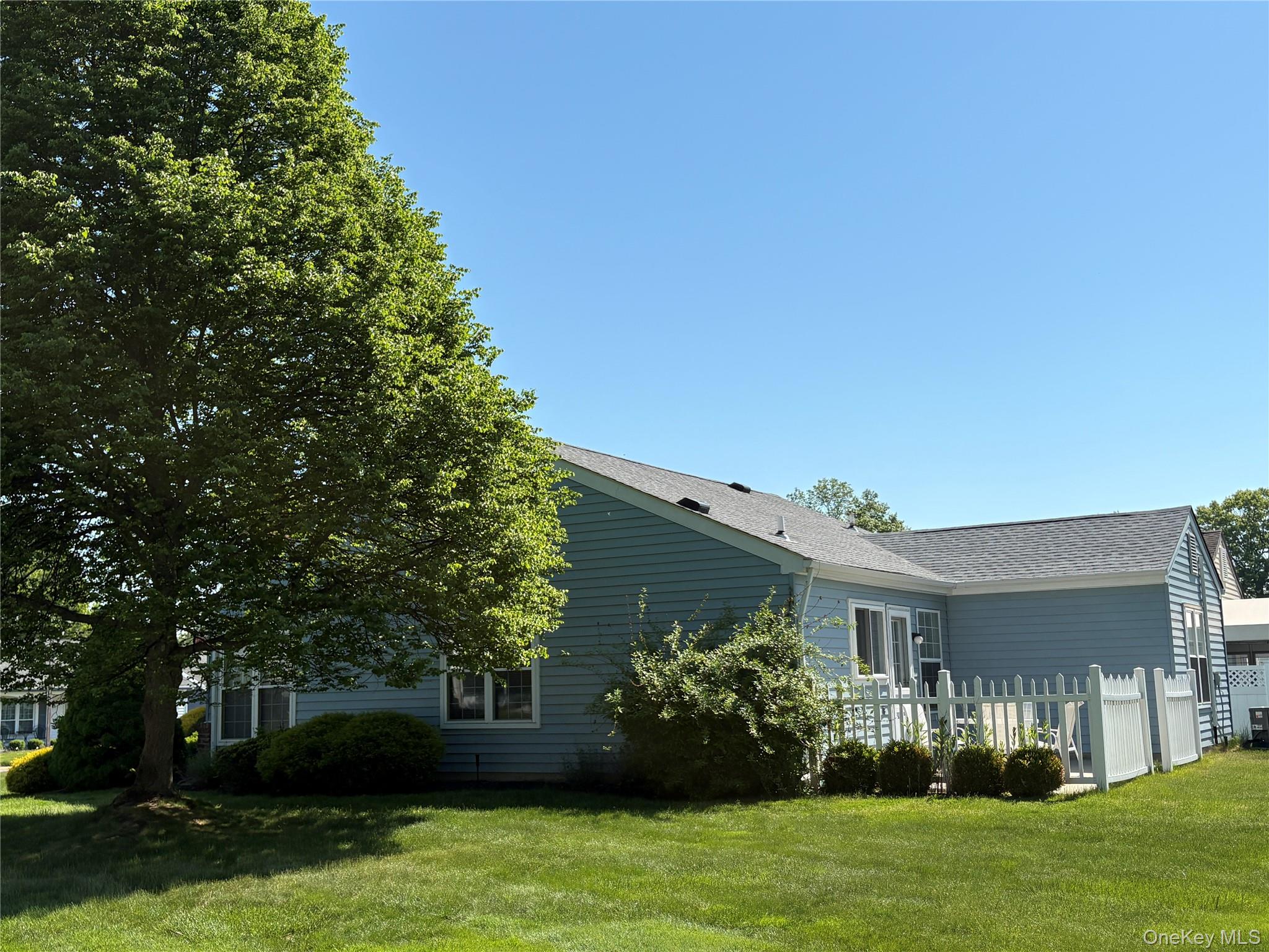 491 Stratford Lane Ridge, NY 11961 - Photo 19 of 24 a front view of a house with garden
