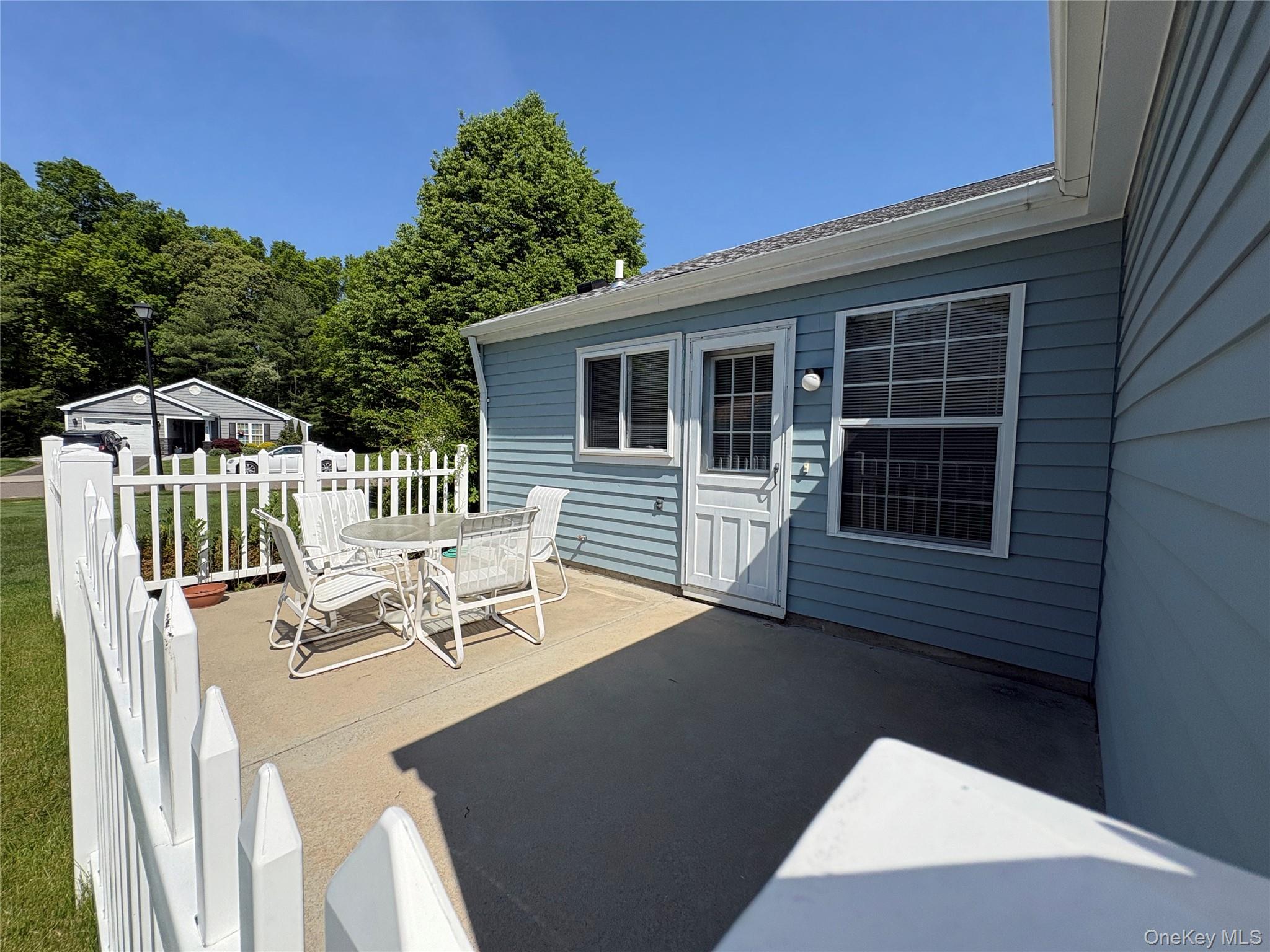 491 Stratford Lane Ridge, NY 11961 - Photo 21 of 24 a view of a patio with a table and chairs