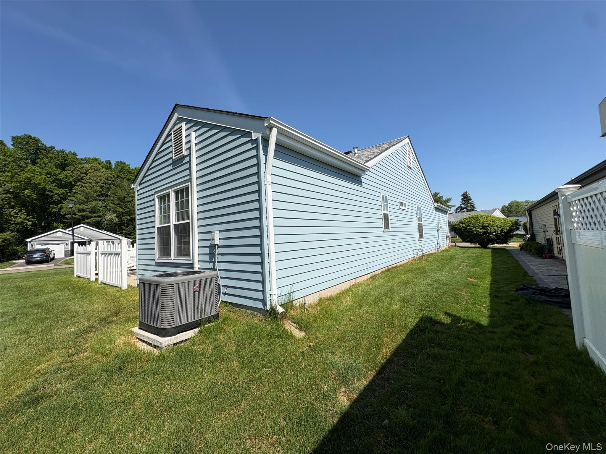 491 Stratford Lane Ridge, NY 11961 - Photo 22 of 24 a front view of a house with garden