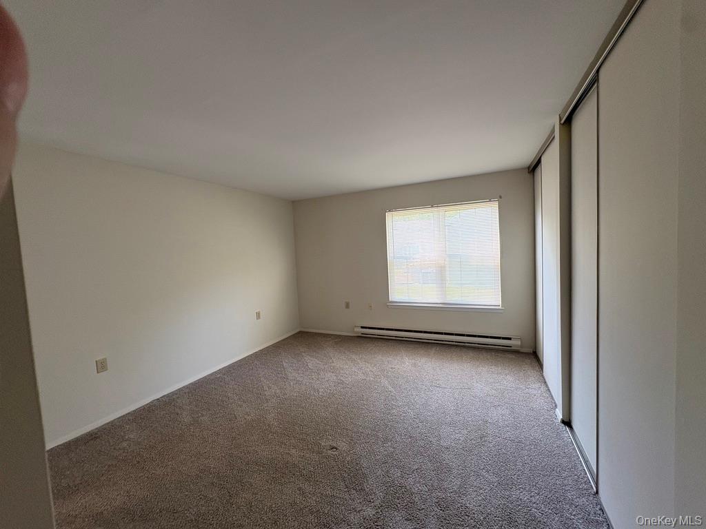 491 Stratford Lane Ridge, NY 11961 - Photo 8 of 24 a view of a room that has window in it