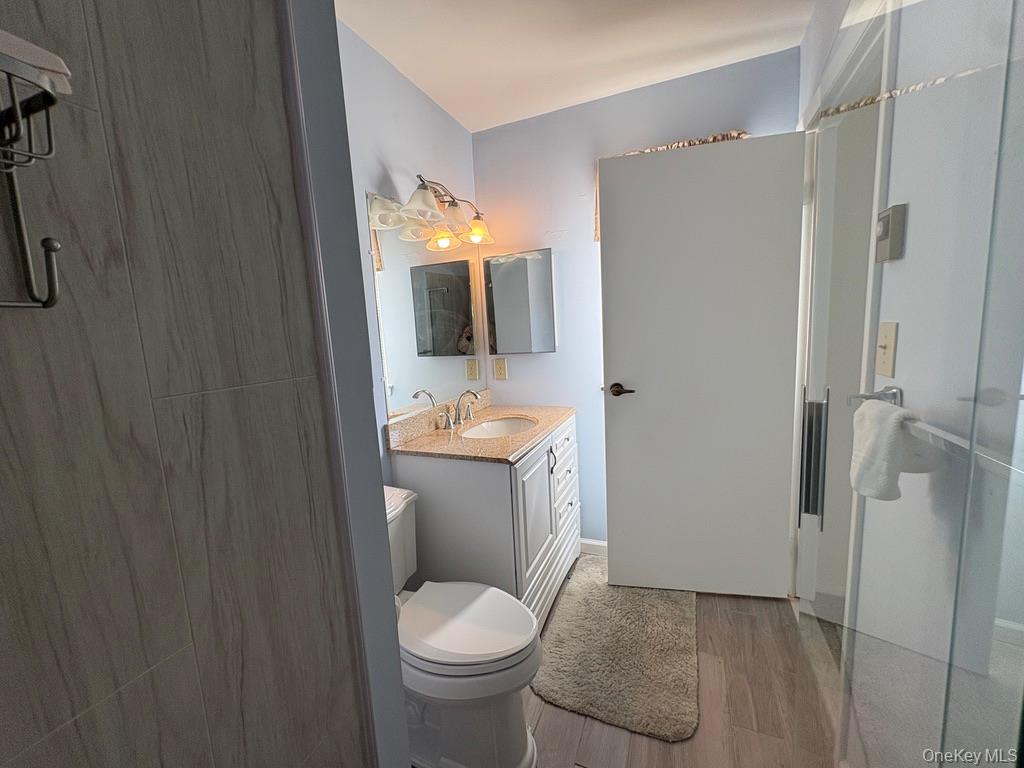491 Stratford Lane Ridge, NY 11961 - Photo 10 of 24 a bathroom with a sink toilet and shower