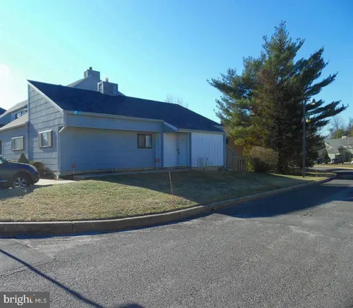 a brick house with yard in front of it